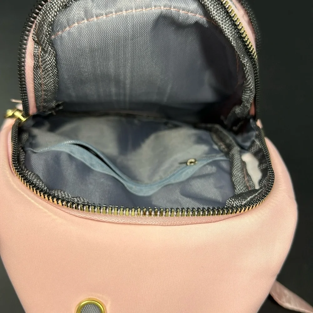 Pink Cross Body Backpack with gold zipper pockets